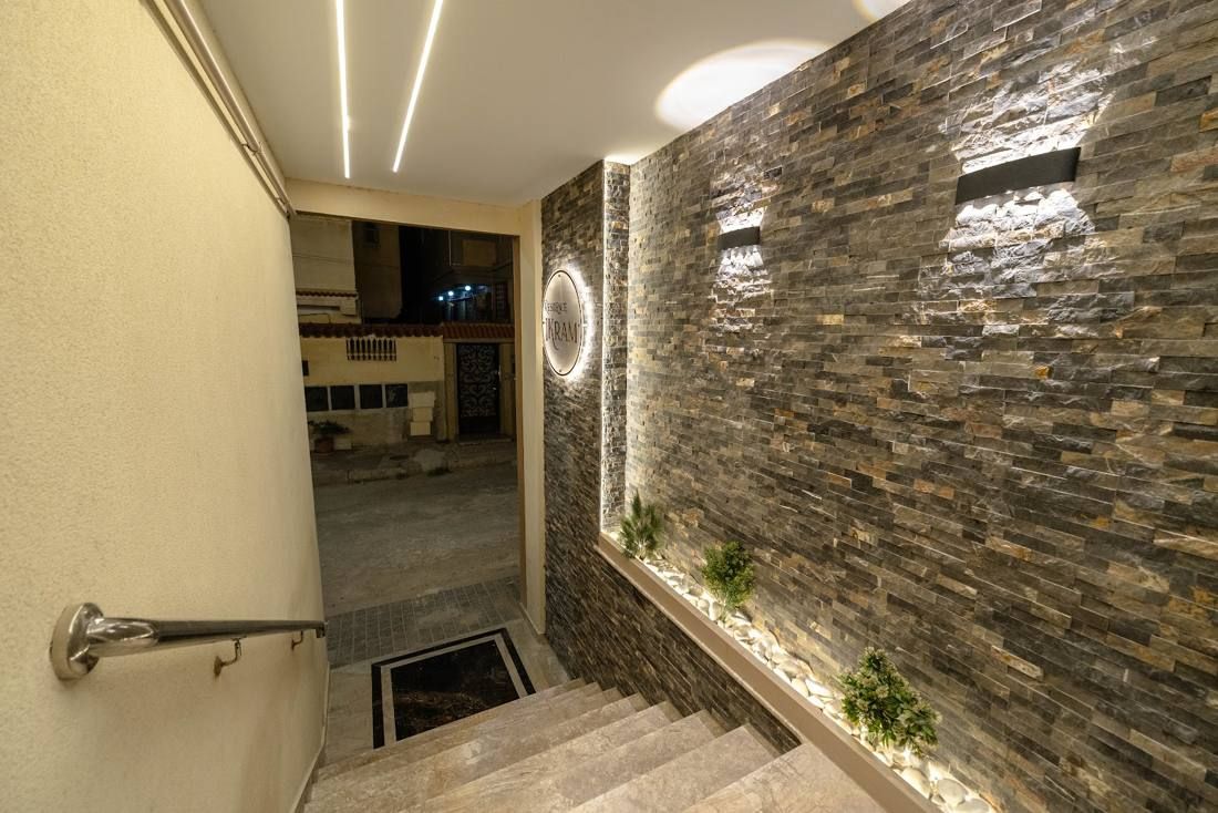 Stone-clad entrance hall with wall lights