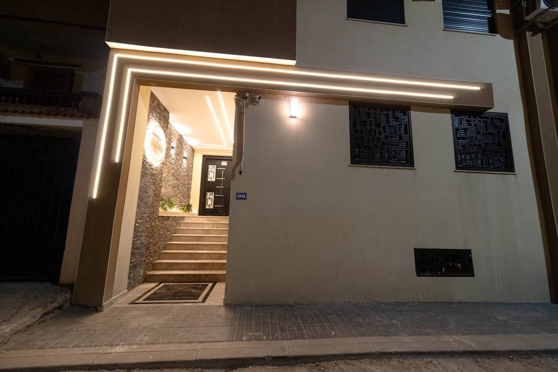 Lit entrance of a residential building at dusk