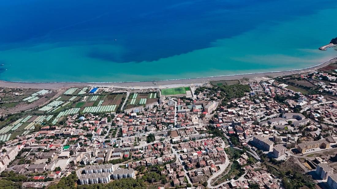 Aerial view of a coastal town and turquoise sea